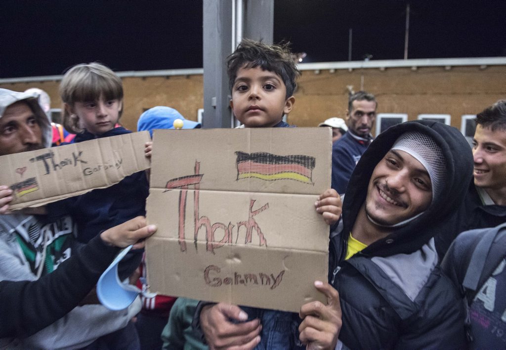 Refugees arrive at the train station in Saalfeld, central Germany, Saturday, Sept. 5, 2015. Hundreds of refugees arrived in a train from Munich to be transported by busses to an accommodation centre. (AP Photo/Jens Meyer) Refugees arrive at the train station in Saalfeld, central Germany, Saturday, Sept. 5, 2015. Hundreds of refugees arrived in a train from Munich to be transported by busses to an accommodation centre. (AP Photo/Jens Meyer)